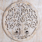 Close up image of a hand-carved mango wood wardrobe with Tree of Life design, distressed finish, ideal for bohemian interiors, 90 × 40 × 180 cm.