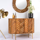 Side angle image of a mango wood furniture cabinet with brass-coated handles and bold texture