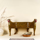 Bold hand-painted bench made from reclaimed wood, designed with double tiger heads at each end and a vibrant yellow-and-black striped pattern throughout, combining whimsical animal form with striking folk-art flair.

