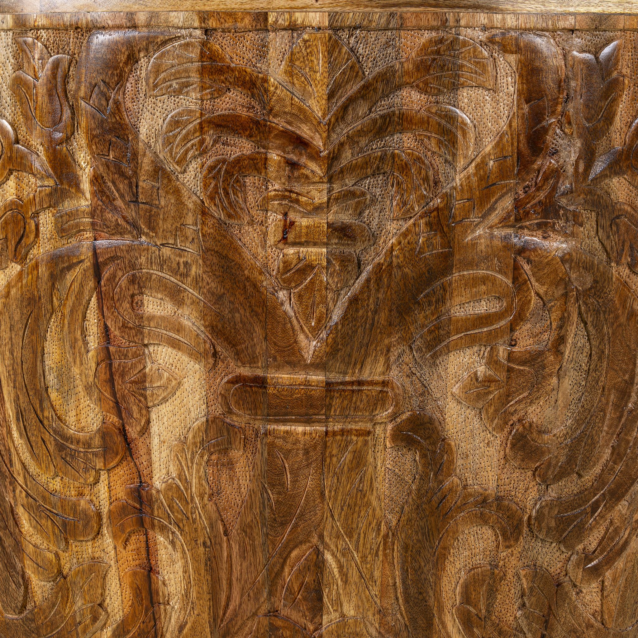 Close up view of a elegant round hand carved coffee table made of sustainable Mango wood with floral design.