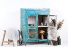 Open door view of a blue vintage glass door cabinet made of reclaimed wood with added decoration.