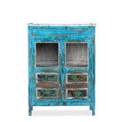White background picture of a blue vintage glass door cabinet made of reclaimed wood with added decoration.