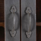 Close up image of a refurbished teak wood cabinet with shabby chic grey finish and glass-panelled doors – sustainable furniture for elegant living and dining spaces.