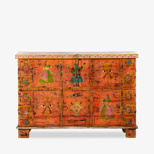 White background image of a recycled teak wood chest with hand-painted Indian motifs in orange – sustainable furniture with vibrant character and cultural craftsmanship.