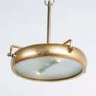 Side angle image of a large round pendant lamp with clear hand-blown glass and brass-plated iron frame – retro lighting and artsy lamp ideal for kitchens, living rooms, or dining areas.