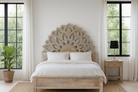 Lifestyle image of a hand-carved wooden bed frame in mango wood featuring an intricate lotus flower design – Lotus bed 180x200 cm by Om Home & Garden