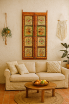 Living room with beige sofa, wooden coffee table, and decorative wall art.