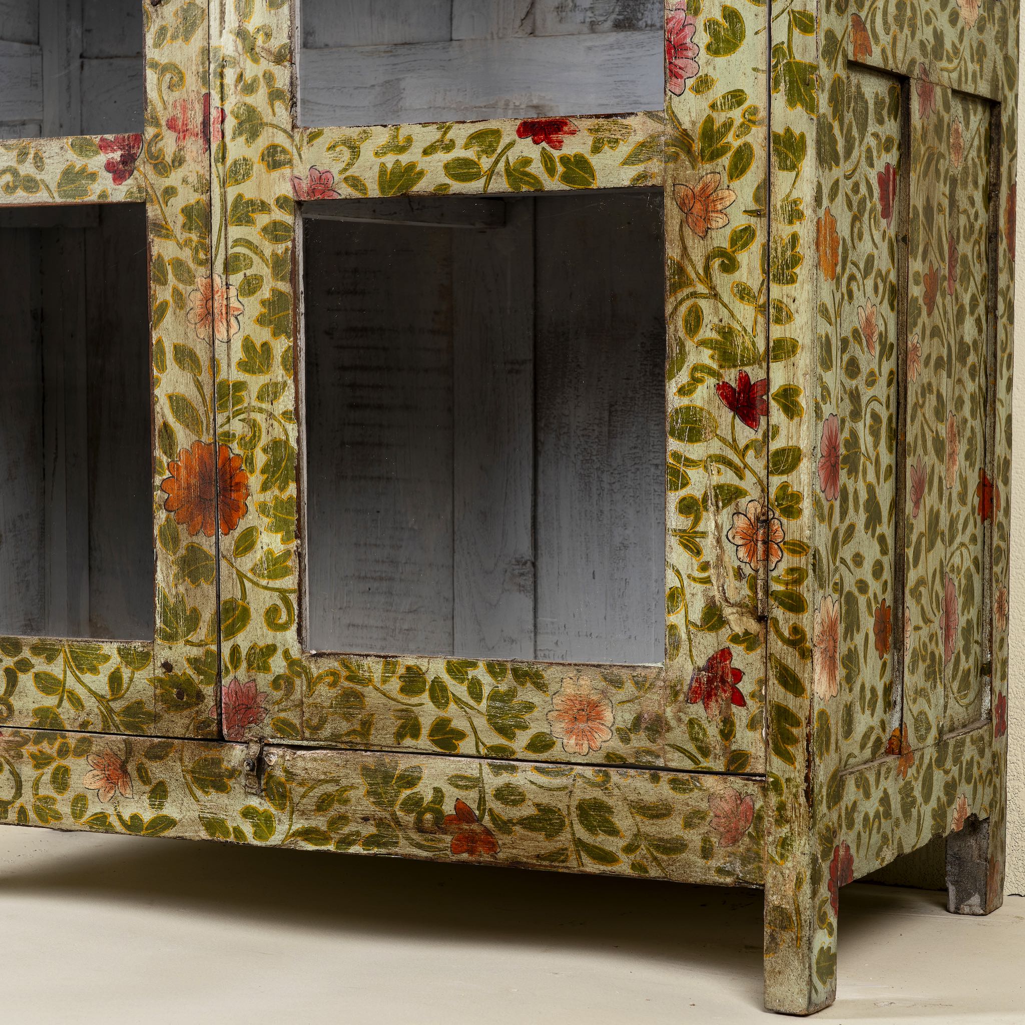 Close up image of a hand-painted reclaimed wood showcase cabinet with floral motifs and glass doors, sustainable furniture and vintage home decor style, 95 × 48 × 183 cm.