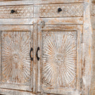 Close up picture view of a hand carved Mango wood sideboard with floral design, 4 doors and 4 drawers in vintage distressed look.