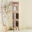 Side angle with open shutter of a mirror stand crafted from reclaimed teak wood with intricate carved detailing and two storage cabinets, set on a sturdy iron base, blending rustic charm with vintage Indian architectural elements.
