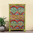 Hand-painted cabinet made from reclaimed wood with colourful floral motifs – a sustainable furniture piece ideal for expressive Indian home decor.