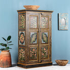 Side angle image of a hand-painted cabinet made from recycled wood with floral motifs – sustainable furniture and unique furniture for bold, artistic interiors.