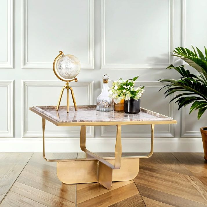 Lifestyle imagination of a square metal coffee table with brown marble top and copper-finished iron base; marble top coffee table, 76 × 76 × 46 cm.