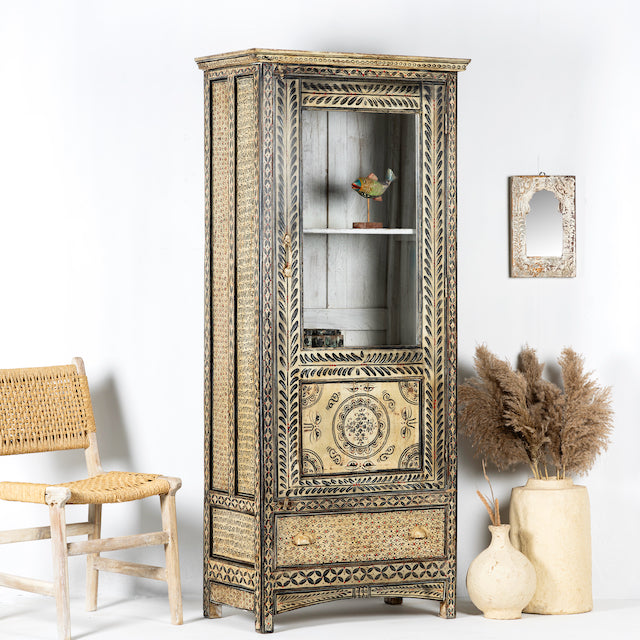 Side angle image of a hand-painted Indian display cabinet with engraved Sanskrit motifs, drawer and compartments – unique Indian furniture made from recycled wood with artisanal detail.