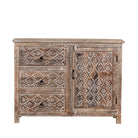 White background image of a hand-carved sideboard made from mango wood, featuring intricate geometric and floral patterns across the drawers and cabinet door, with a distressed whitewashed finish that enhances its vintage artisanal appeal.
