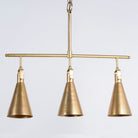 Three-light iron pendant lamp with brass finish and tapered design – minimalistic style lighting and iron pendant lights for modern interiors.