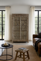 Lifestyle scene of a reclaimed wood wardrobe made with antique door panels – a handcrafted piece of old door furniture perfect for Indian home decor and rustic interiors.