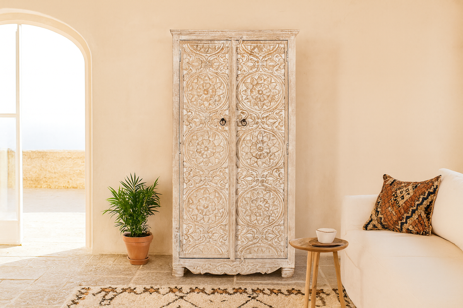 Life style image of a hand-carved mango wood wardrobe with whitewashed finish; wooden wardrobe perfect for living room furniture or bedroom storage, 180 × 90 × 40 cm.
