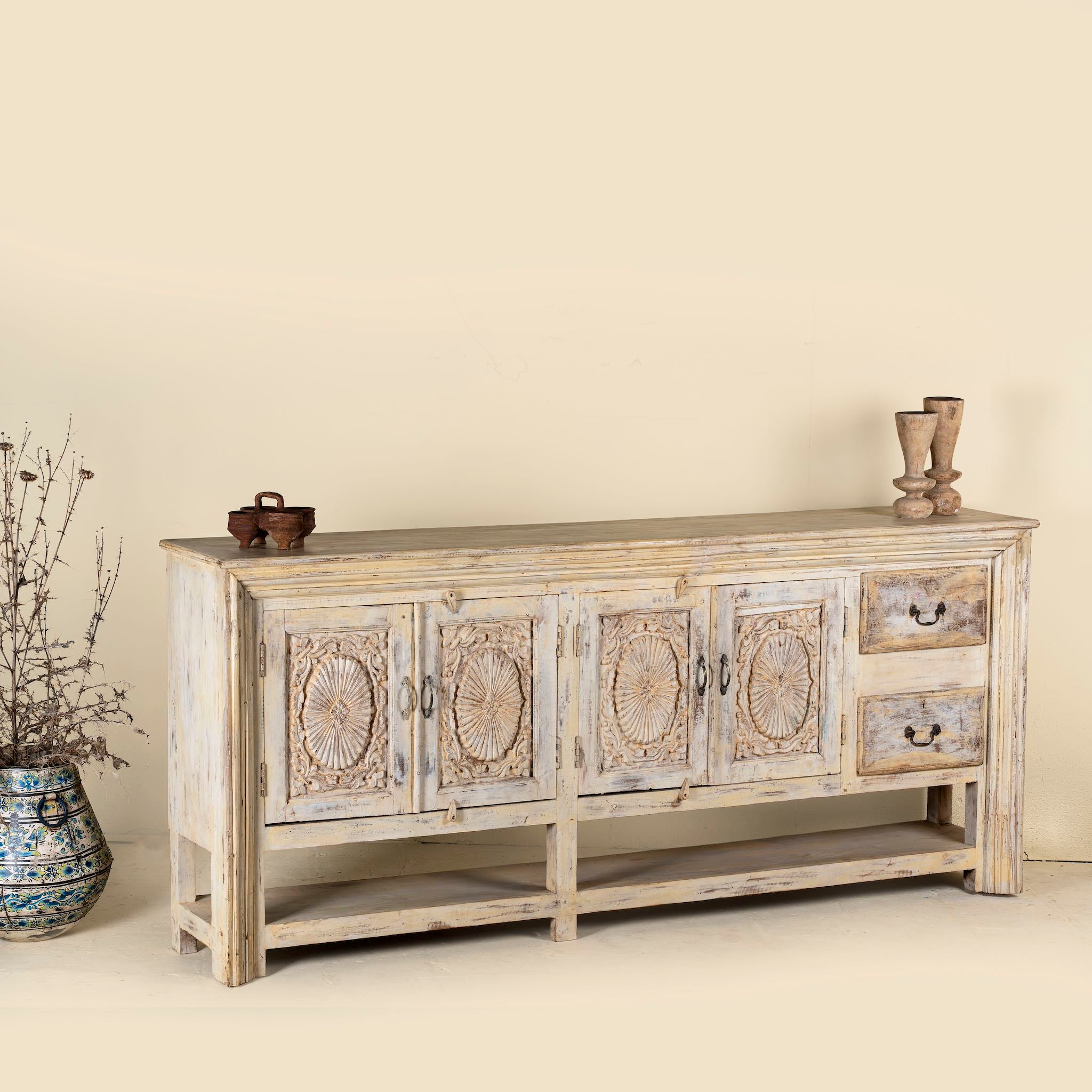 Side angle image of a antique console table wood with carved teak front, part of our teakwood tables collection.