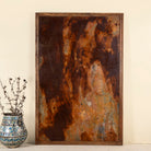 Unique iron wall decoration featuring a naturally rusted iron panel with abstract patterns, framed in solid teak wood – ideal for modern and industrial interior decor.