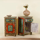 Side angle image with open door of a Hand-painted bedside tables made from recycled wood – vintage night stands with carved mango wood furniture detailing and floral artistry.