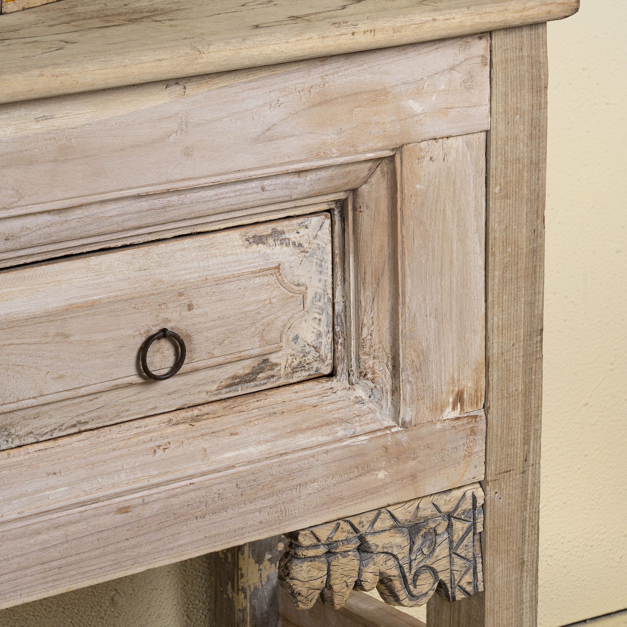 Close-up of a carved console table made from reclaimed teak, a refined example of unique wooden furniture.