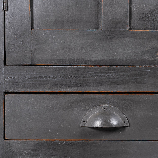 Close up image of a shabby chic grey teak wood cabinet with glass doors and drawers – sustainable furniture for classic, rustic, or vintage interiors.