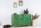 Side angle image of a handcrafted sideboard made from reclaimed teak and recycled wood, hand-painted in green – sustainable furniture with artistic character.