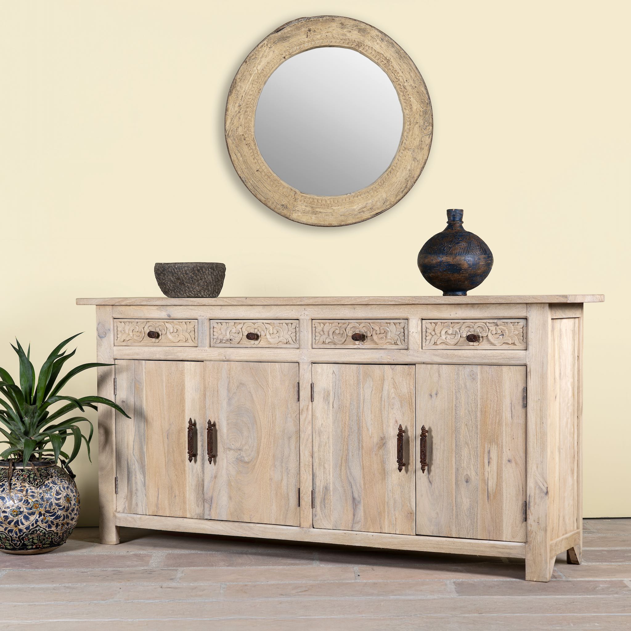 Side angle image of a hand-carved mango wood sideboard with sandblasted finish – a rustic mango wood furniture piece ideal for Ibiza style interiors.
