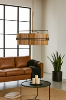 Lifestyle image of a rustic single light pendant lamp with Mango wood and antique brass iron frame – minimalistic style lighting ideal for dining tables, kitchen islands, or cozy living areas.