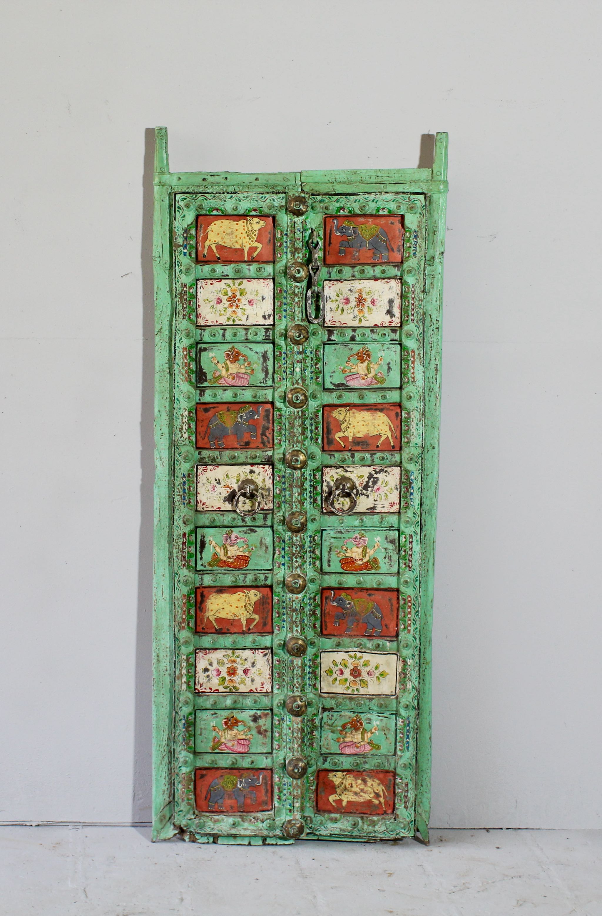 Vintage Indian antique door panel in distressed teal with hand-painted sacred and floral motifs, repurposed as wall art and vintage home decor.