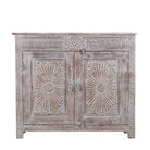 Close up image of a grey-washed reclaimed wood cabinet with hand-carved floral and sunburst detailing, a vintage furniture piece perfect for rustic or bohemian interiors.