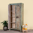 Side angle image with open doors of a hand-carved reclaimed wood wardrobe with vintage sunburst design – a sustainable furniture piece perfect for Indian home decor and rustic interiors.