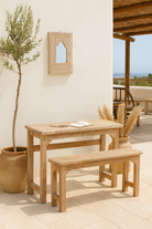 Lifestyle imagination of a teak wood bench set made from refurbished wood with hand-carved detailing and rustic finish, 120 × 30 × 65 cm.