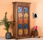 Side angle image of a hand-painted cabinet made from reclaimed teak wood with colourful Indian motifs – sustainable furniture and vintage teak wood craftsmanship for bold interiors.