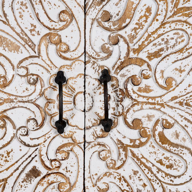 Close up image of a hand-carved mango wood wardrobe with whitewashed floral motifs – Zashil by Om Home & Garden, a Mediterranean-inspired piece of carved wooden furniture.