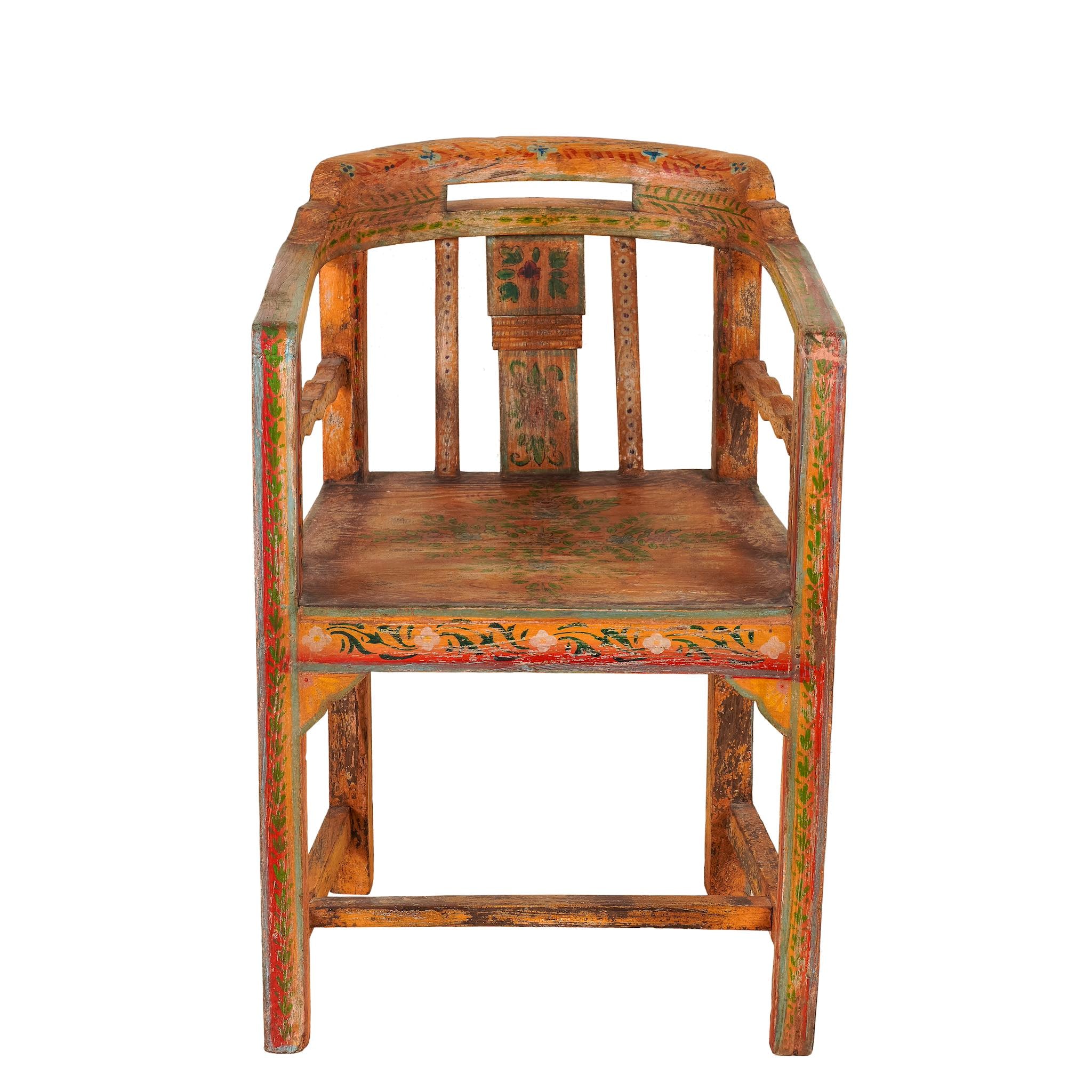 White background image of a hand-painted armchair with floral design crafted from reclaimed teak wood, featuring intricate traditional patterns in earthy tones on the backrest, seat, and frame, with a rustic and vintage finish.
