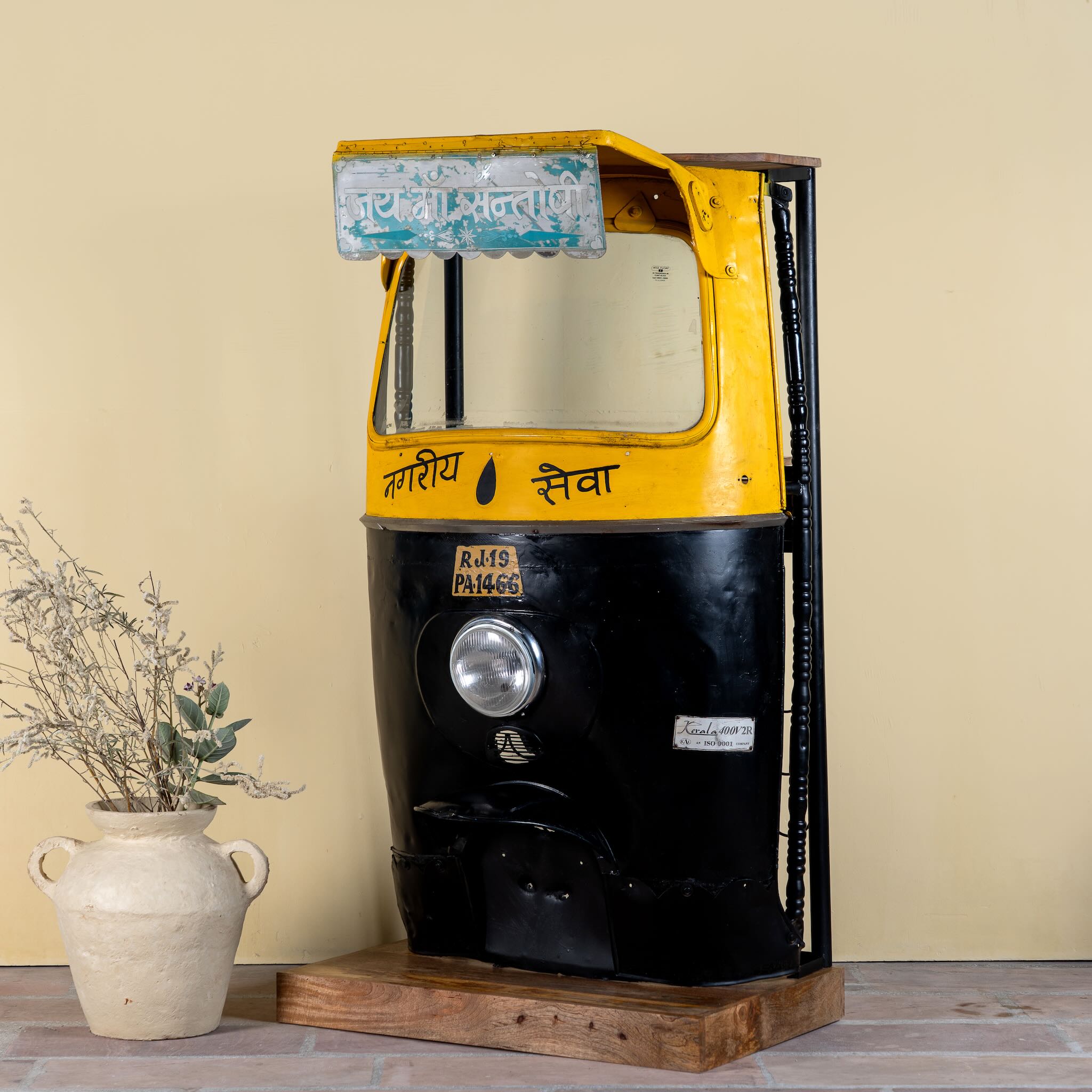 Side angle image of a artsy bar table made from a reclaimed Indian rickshaw front with working headlight – Zoha Riksha bar model by Om Home & Garden