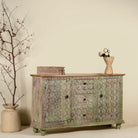 Side angle image of a carved wooden furniture sideboard with floral hand-carving and distressed finish, vintage style cabinet made from mango wood, 150 × 40 × 90 cm.