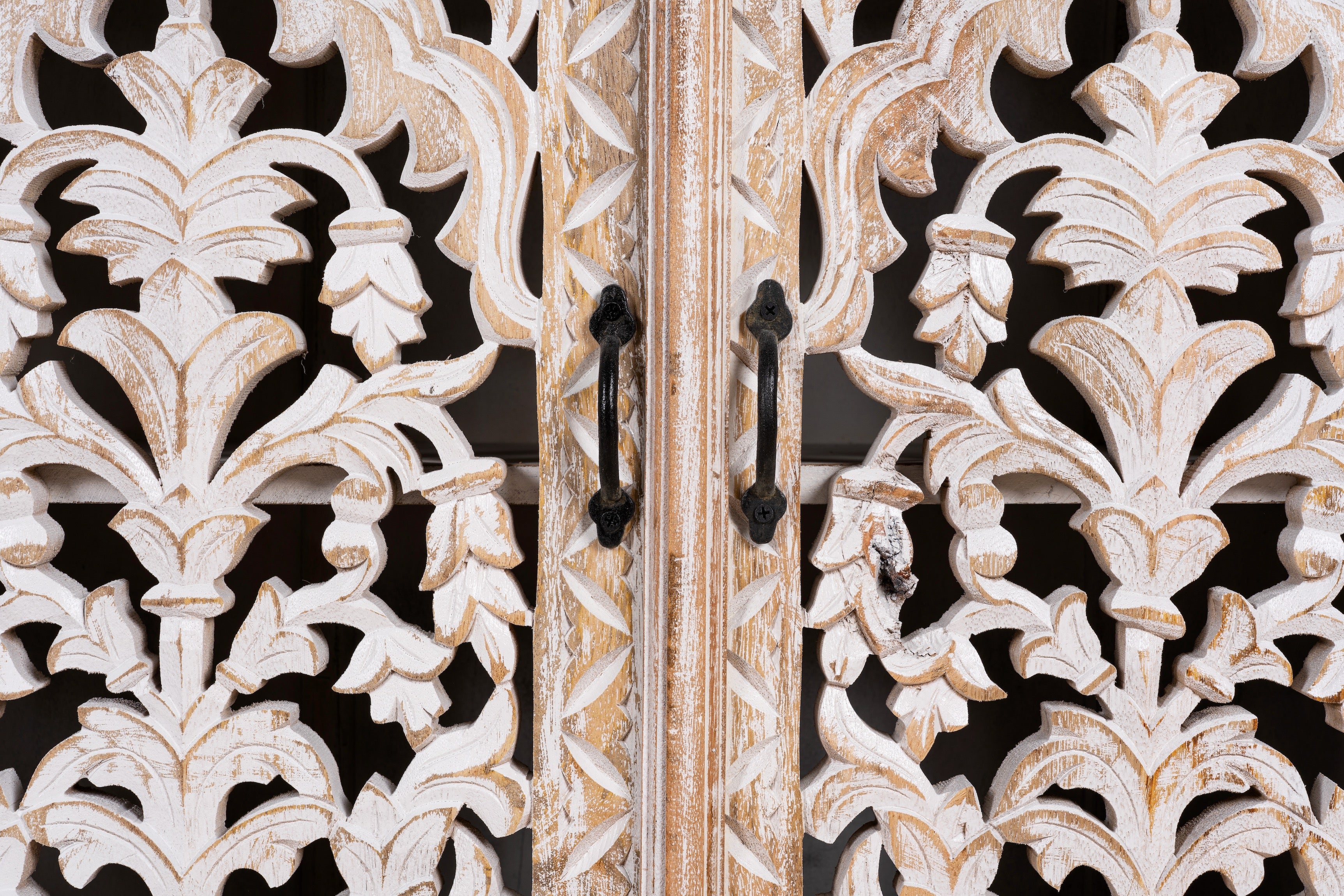 Close up image of a hand carved mango wood sideboard with whitewashed finish and intricate Indian patterns; ideal for bedroom furniture or as a hand carved sideboard, 180 × 90 × 40 cm.