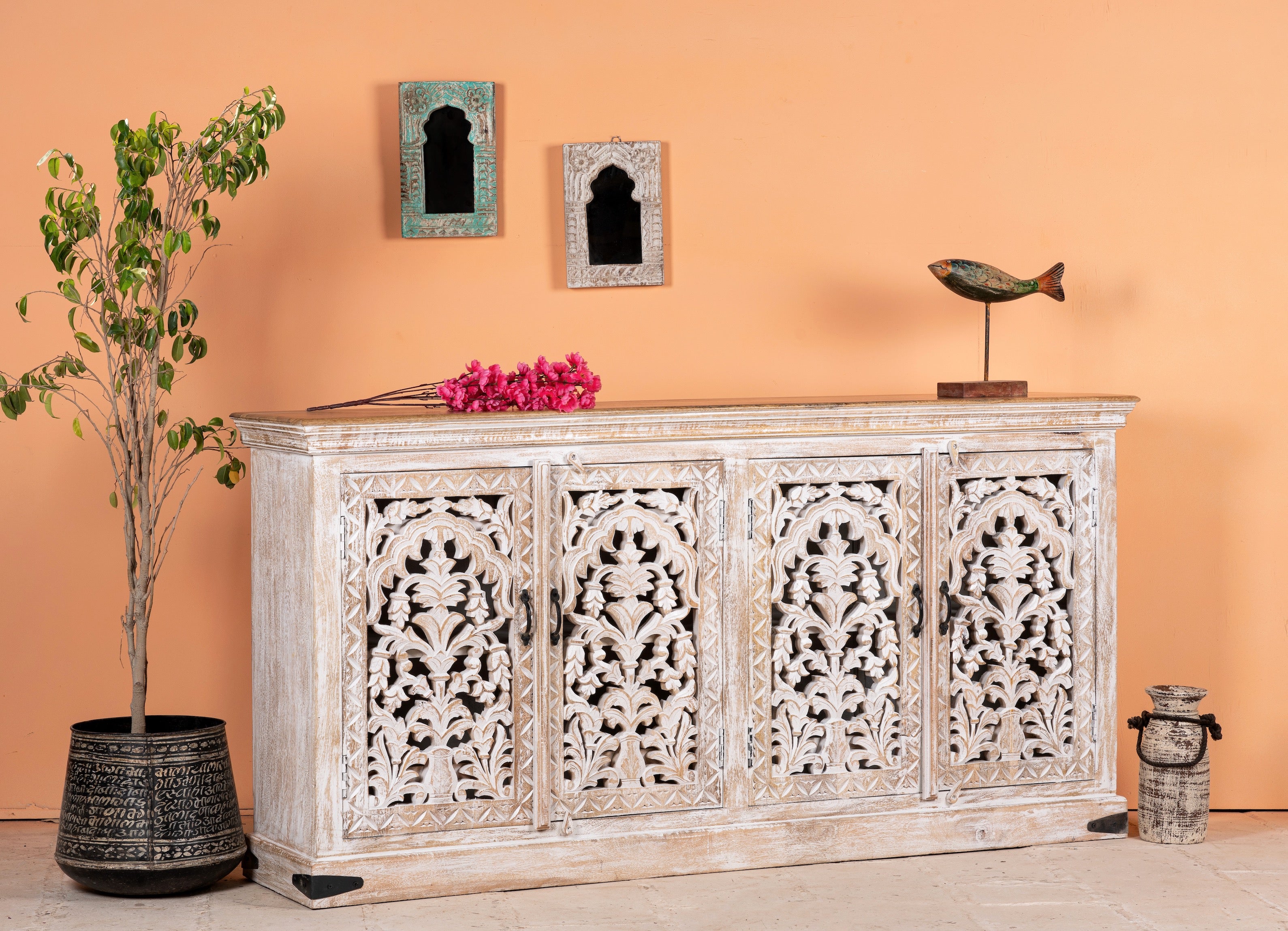 Side angle image of a hand carved mango wood sideboard with whitewashed finish and intricate Indian patterns; ideal for bedroom furniture or as a hand carved sideboard, 180 × 90 × 40 cm.