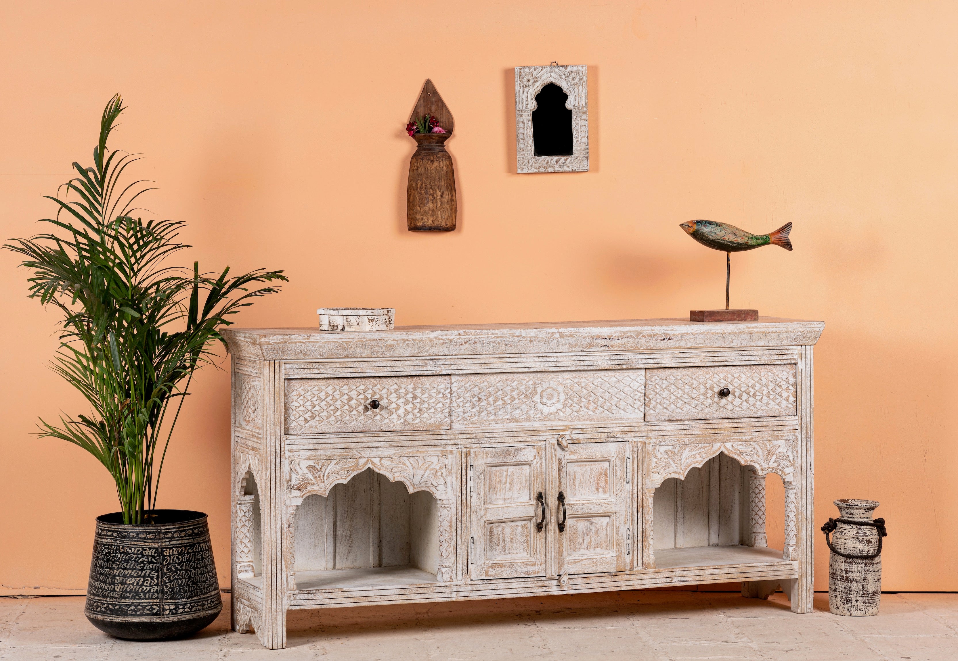 Side angle image of a hand-carved console table in mango wood with whitewashed finish, perfect for a bohemian interior.