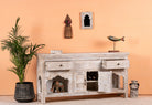 Open drawers and doors image of a hand-carved console table in mango wood with whitewashed finish, perfect for a bohemian interior.