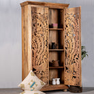 Open door image of a hand-carved mango wood cupboard with Indian peacock design motifs, Mediterranean-style wardrobe; elegant mango wood furniture, 190 × 100 × 40 cm.
