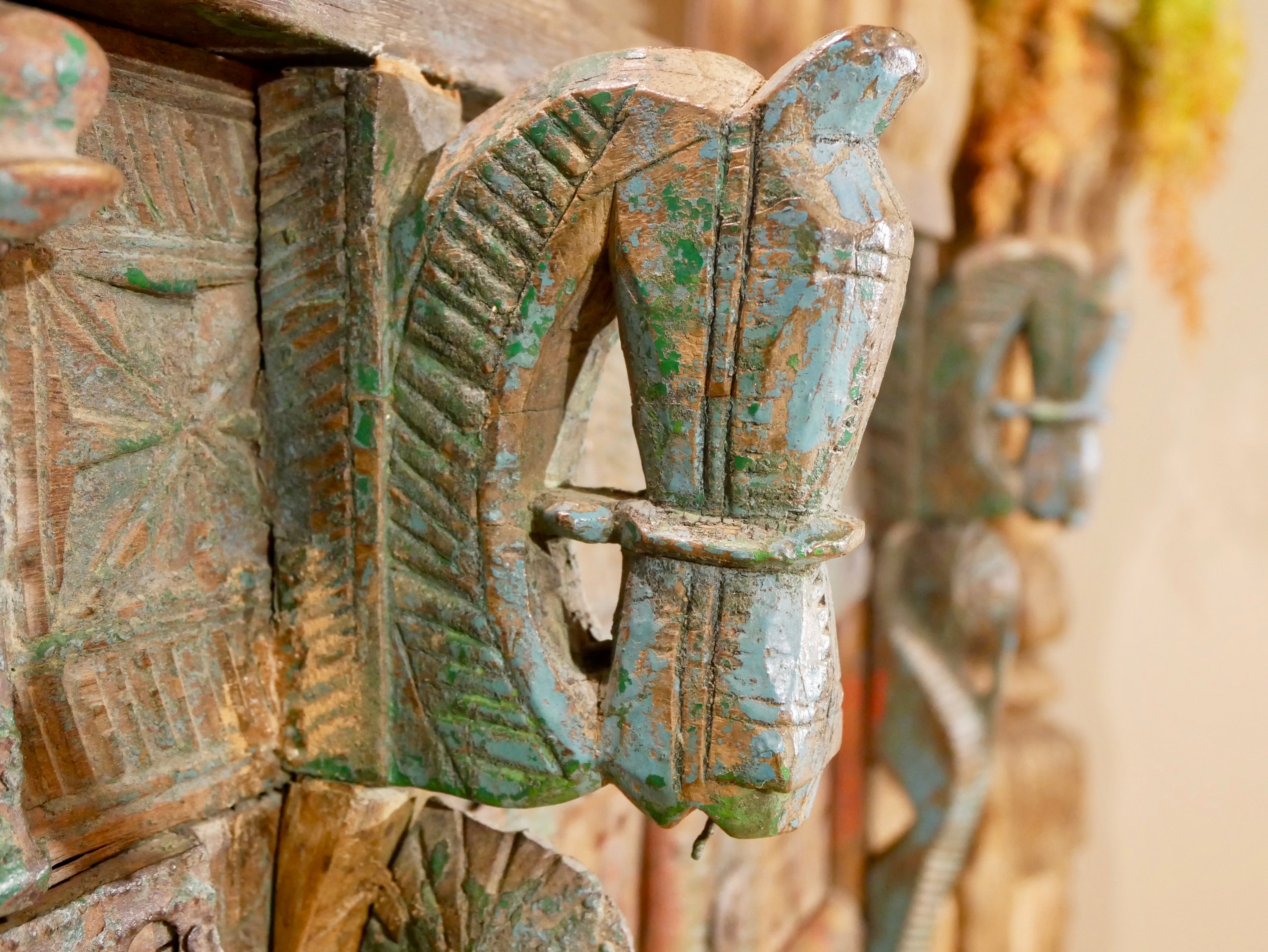 Close up image of a classic Indian furniture Damchya chest, reclaimed teak wood with hand-carved details and iron fittings; perfect for bohemian interior décor, 130 × 66 × 110 cm.