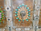 Close up image of a teak wood console table made from recycled antique house parts with hand-painted front; sustainable furniture, 183 × 85 × 42 cm.