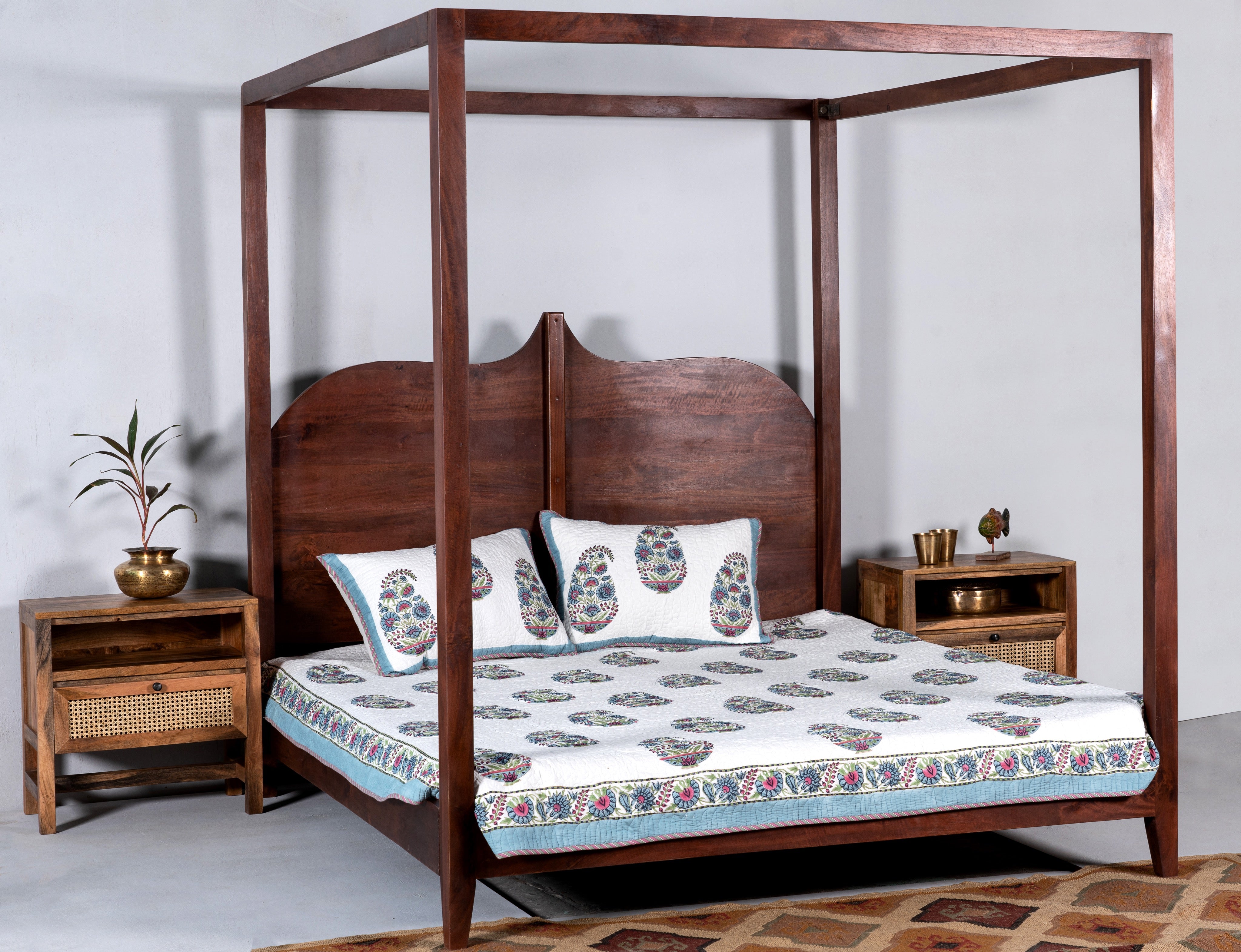 Lifestyle image of a mango wood bedside table with rattan insert, handcrafted rattan furniture; durable mango wood furniture, 60 × 60 × 40 cm.