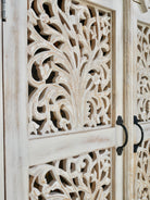 Close up image of a hand-carved mango wood cabinet with white-washed finish – artisanal furniture combining Mediterranean design and functional elegance.