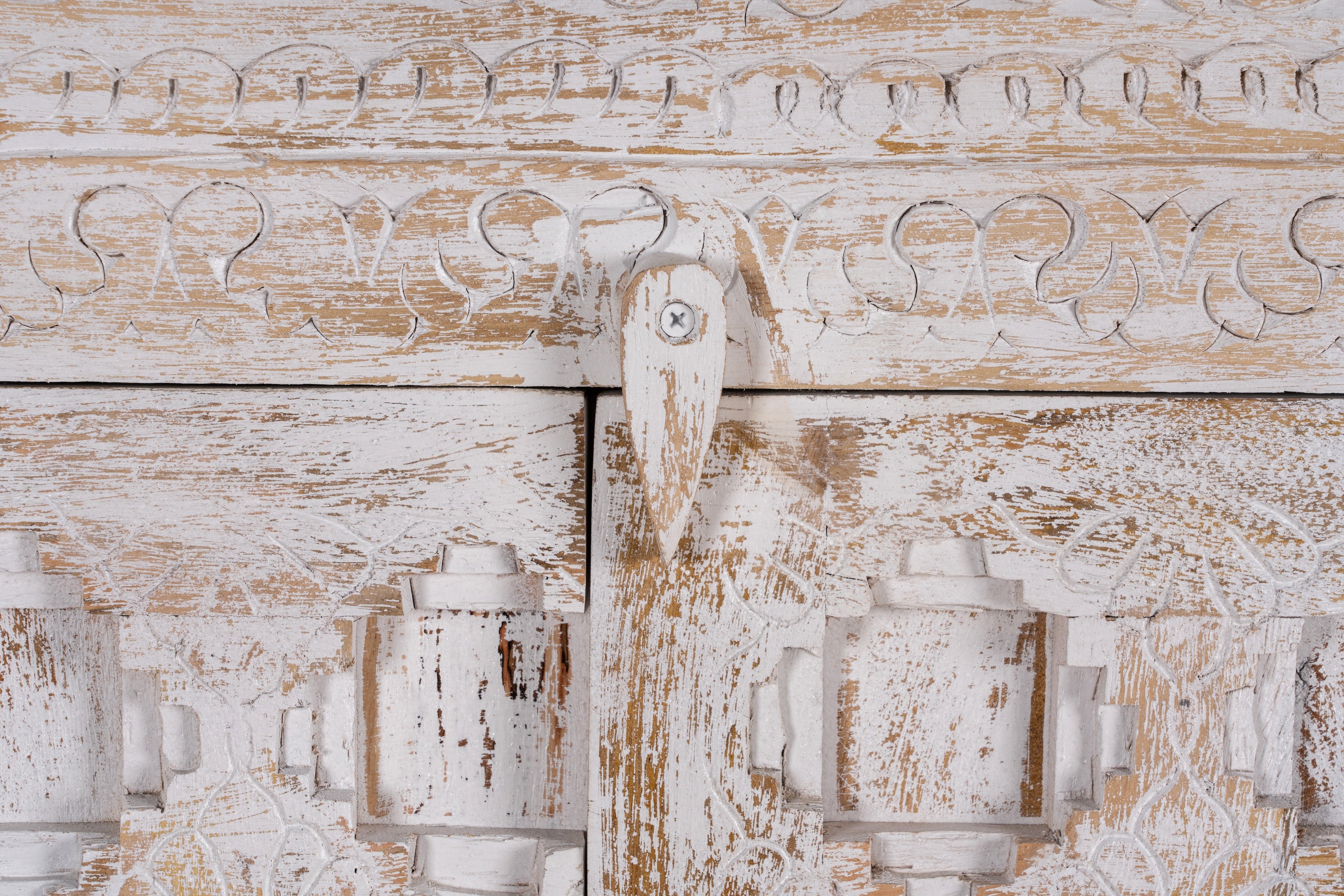Close up image of a handcrafted cabinet made from reclaimed wood with white-washed finish and Indian carvings – sustainable furniture and unique Indian furniture with cultural depth.