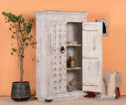 Side angle image with open doors of a handcrafted cabinet made from reclaimed wood with white-washed finish and Indian carvings – sustainable furniture and unique Indian furniture with cultural depth.